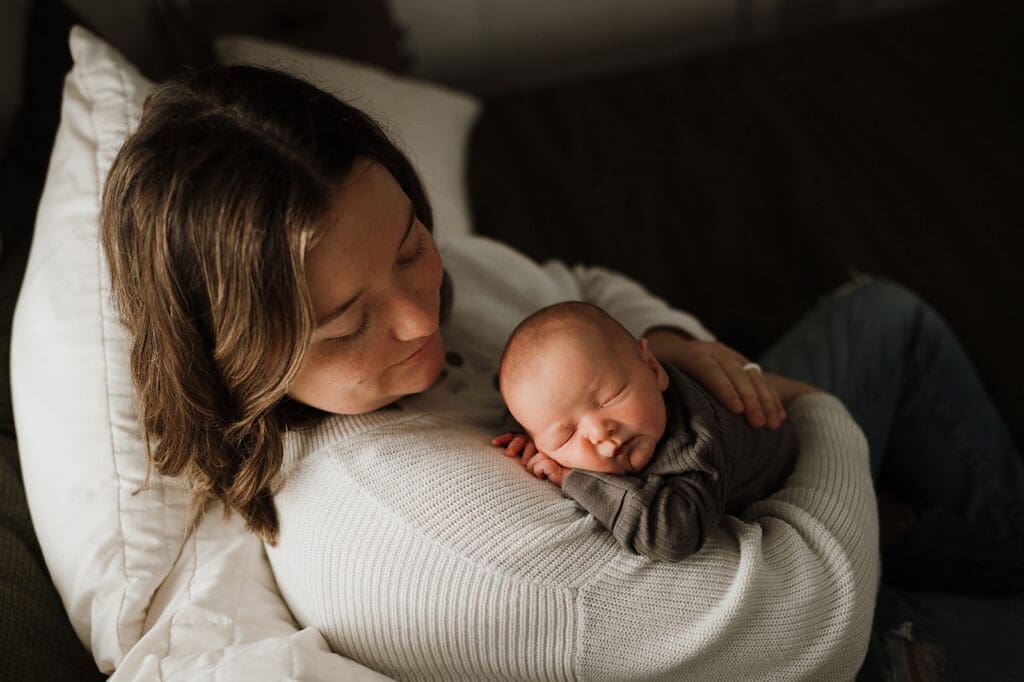Mother holding her newborn daughter during lifestyle newborn session in Southern Ohio